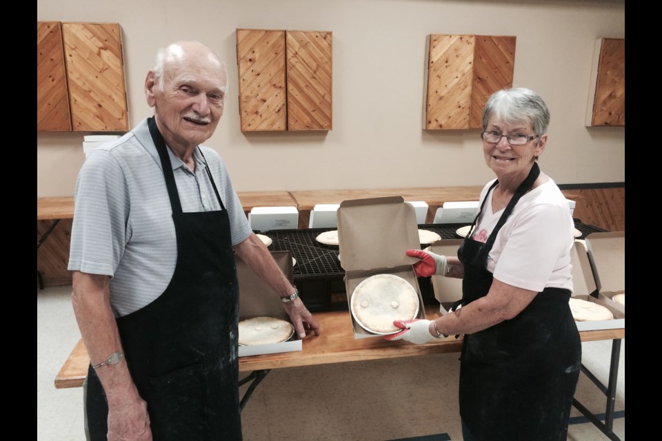 Joe Girard and Lea Bale stand near some of the 264 meat pies baked in one day to help fundraise for the West Ferris Legion fundraiser