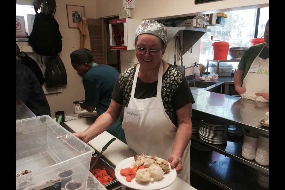 Betty Peever volunteers to serve up a traditional Thanksgiving meal at The Gathering Place 
