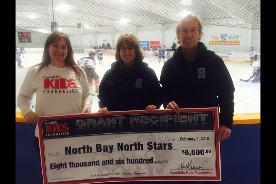 Mariane Wagner presents a cheque from the GoodLife Kids Foundation, to North Bay North Stars President Sharon Fung, and Head Coach David Nadeau to expand their hockey program. 
