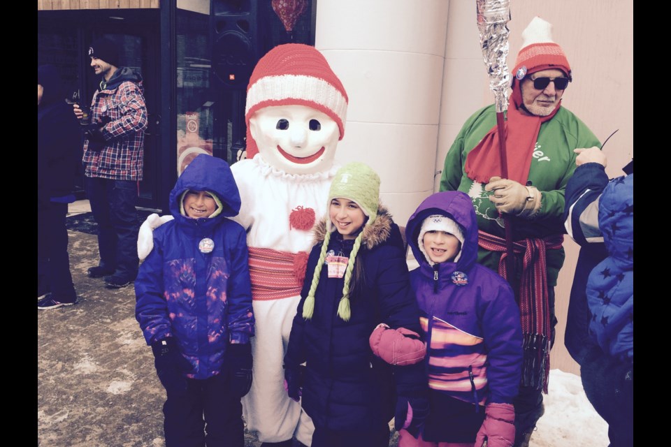 Bonhomme Carnaval poses with children in downtown North Bay