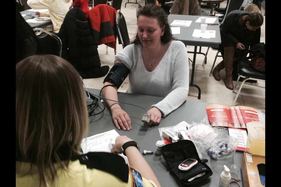 Carrie Gray gets her vitals taken by paramedic Keri Underwood at 'Paramedics and Pancakes' breakfast
