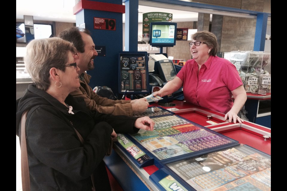 Wingate Lottery owner Cathy Strawn shares a joke with customers. April 30th is her last day on the job. She blames the  minimum wage increase for putting her out of business after 29 years. 