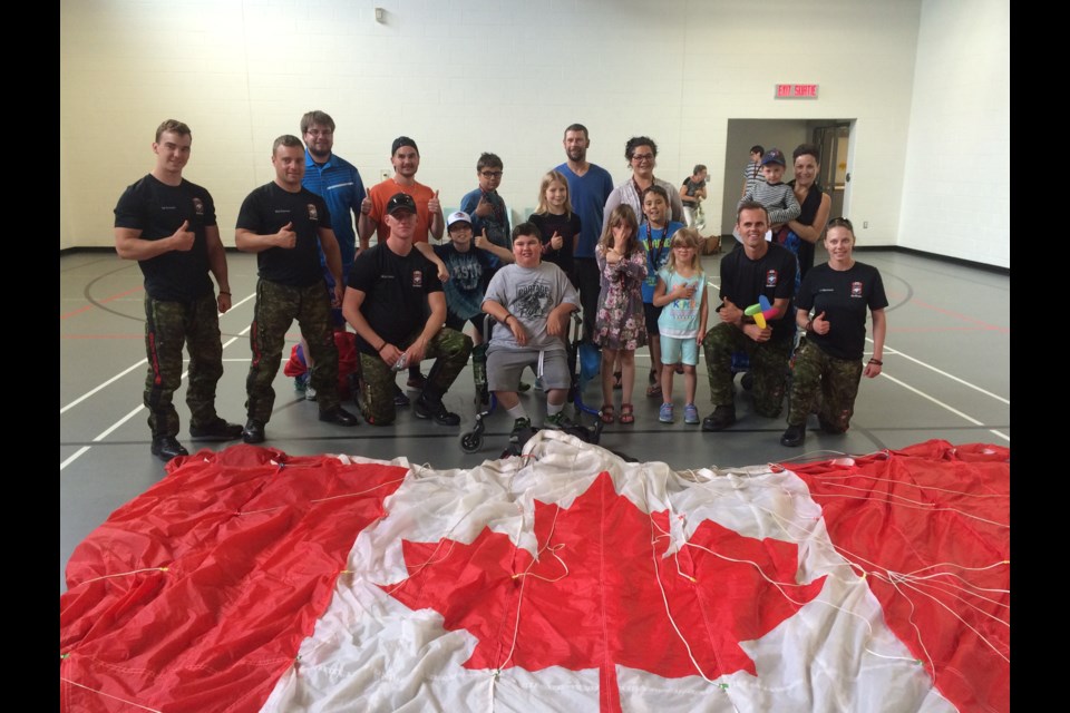 Members of the Canadian Armed Forces Skyhawks parachute team drop in to One Kids Place Treatment Centre  