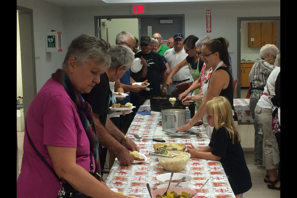 Volunteers serve up French-Canadian fare at Saint Thomas d’Aquin community picnic in Astorville
