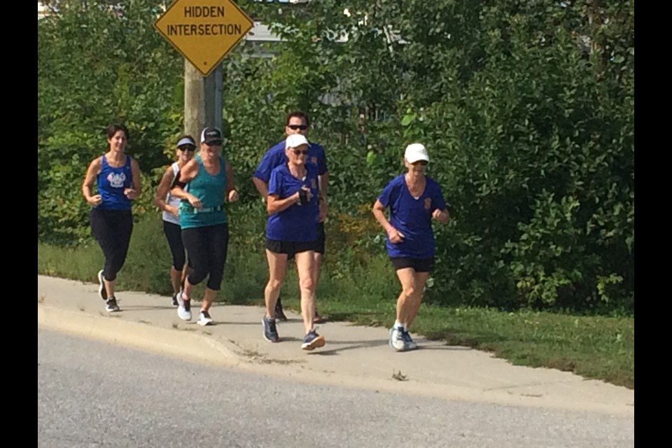 Pam Hansen (front left), Sandy Foster, (front right), Karen-Anne Amyotte (middle left) and Drew Mitchell (middle right) just steps away from completing their run from Sturgeon Falls to North Bay in support of Nipissing Serenity Hospice   