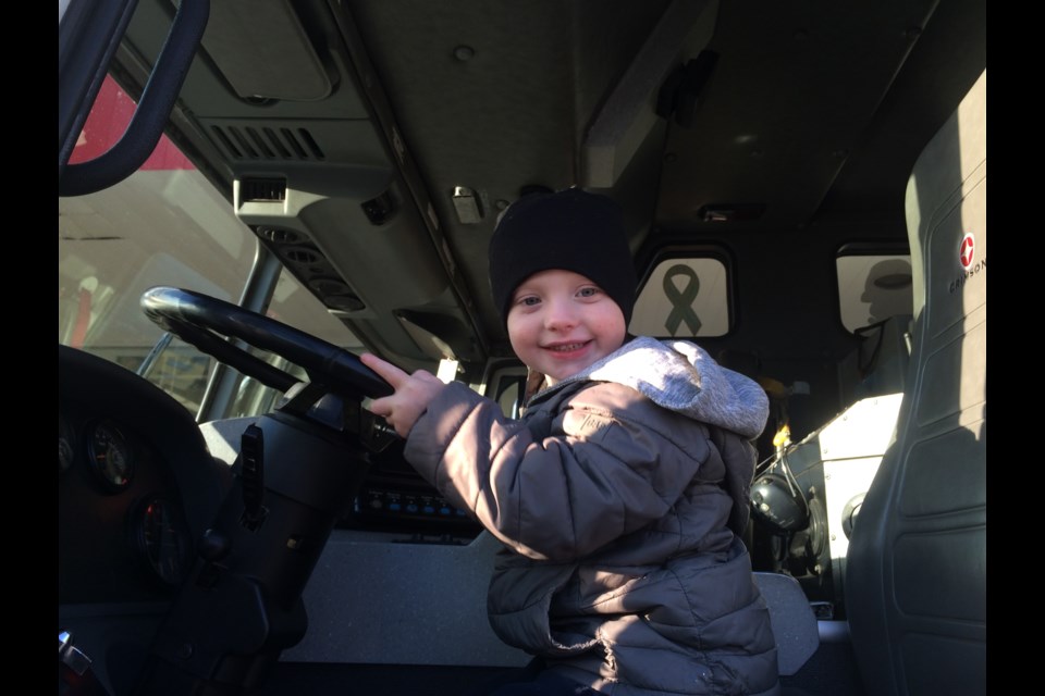 Hudson Ransom sitting big in a North Bay Firetruck during the annual Fill a Firetruck event for the North Bay Food Bank 