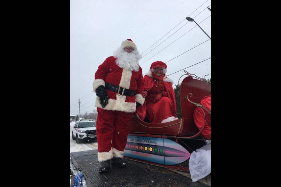Santa and Mrs. Claus enjoy the annual Santa Claus Parade. This year's theme, a Futuristic Christmas
photo courtesy Bryan Kimber