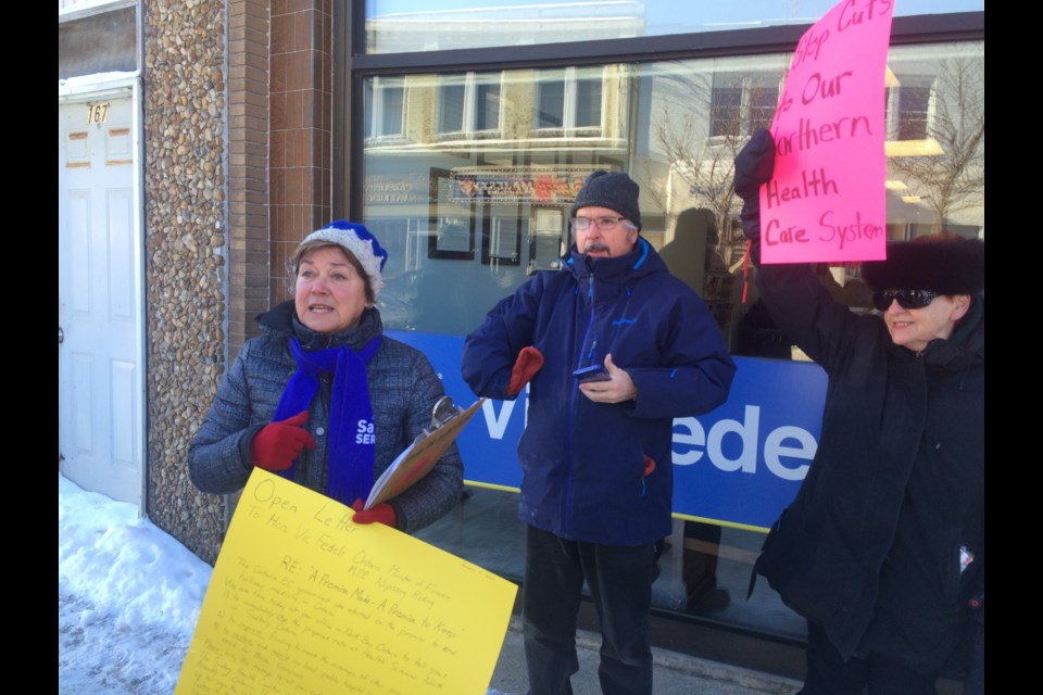 Dot Klein (l) chair Sudbury Health Coalition and Doug Allan Ontario Health Coalition (centre), lead a news conference outside the office of the Minister of Finance in North Bay, saying cuts to Health Sciences North impacts North Bay residents residents (Supplied).