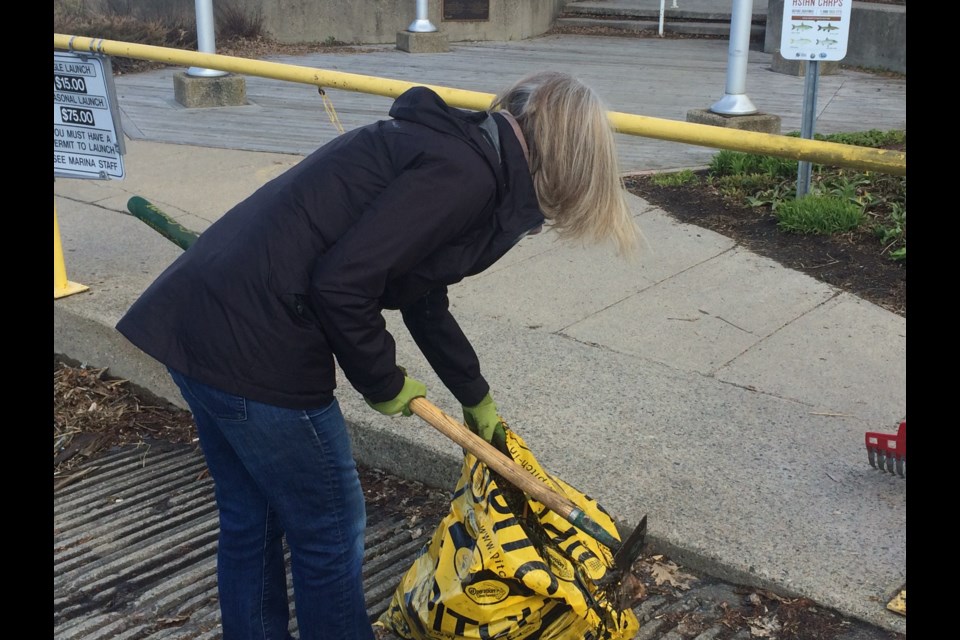 Joanne Weiler cleans up at the waterfront boat launch as part of city-wide clean up blitz