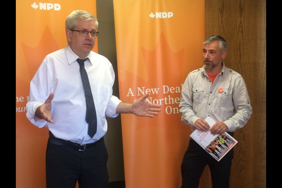 (l-r) Timmins-James Bay NDP candidate Charlie Angus explains the party platform at the opening of Nipissing-Timiskaming NDP candidate Rob Boulet's campaign office.