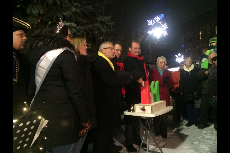 Flipping the switch to light up the Christmas tree at the Downtown Christmas Walk 