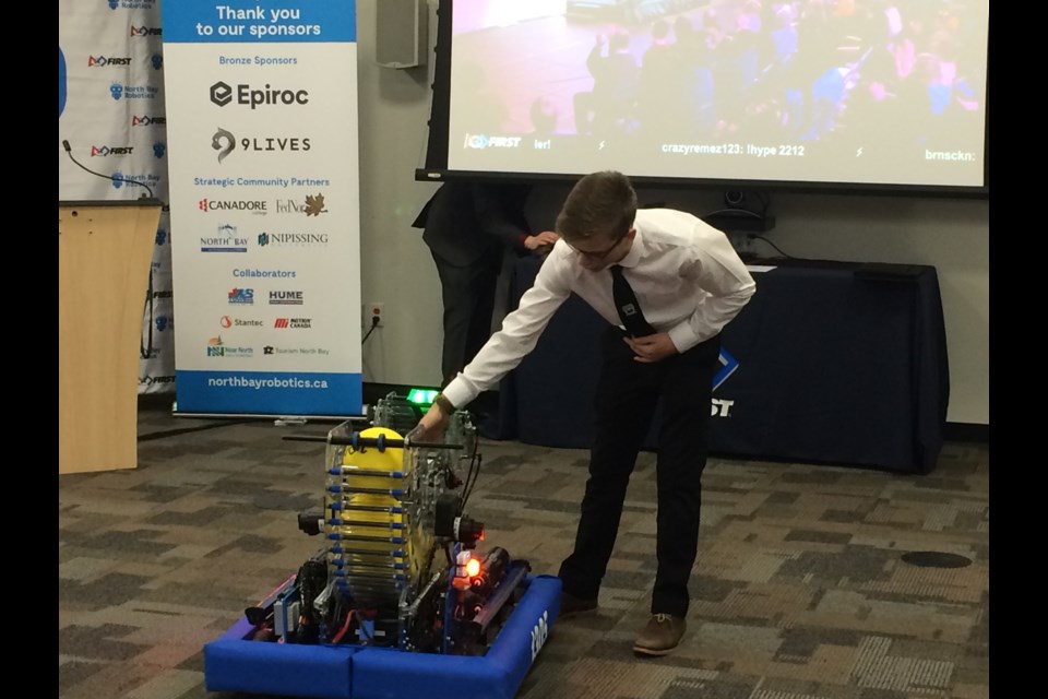 Grade 12 student Jared Kelso with robot his team will use at the North Bay FIRST Robotics Competition in March