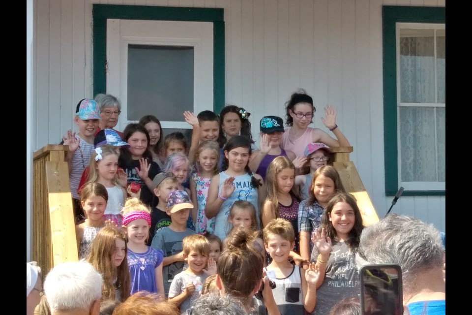 One of two surviving Quintuplets, Annette Dionne poses with the children of North Bay and Area.  