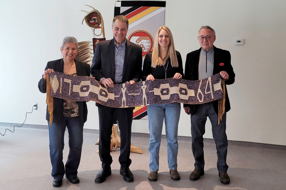 (L-R) Jane Commanda, Nipissing First Nation councillor; MP Anthony Rota; Maggie Horsfield North Bay's deputy mayor, and Maurice Switzer, the president of the North Bay Indigenous Friendship Centre pose with a handcrafted wampum belt after the announcement / Photo David Briggs 