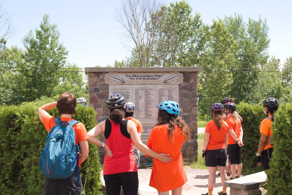 Children reflect upon the Residential School Memorial in Duchesnay before embarking on their ride / Photo David Briggs