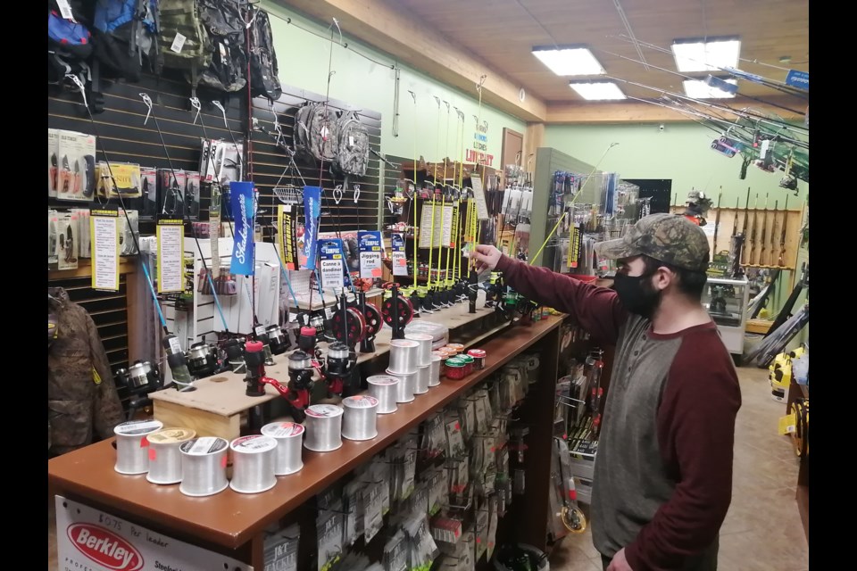 Matt Cropper adjusts some ice-fishing rods at the Backwoods Outdoors live bait and gunsmithing shop at the former North Bay Canoe and Kayak location on Highway 17 near Corbeil Corners, East Ferris. Dave Dale Photo