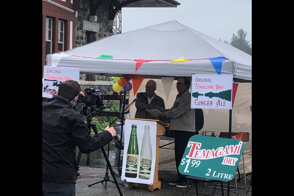 Temagami  Mayor Dan O'Mara accepts trademark documents from Fortier Beverges owner Raymond Fortier.