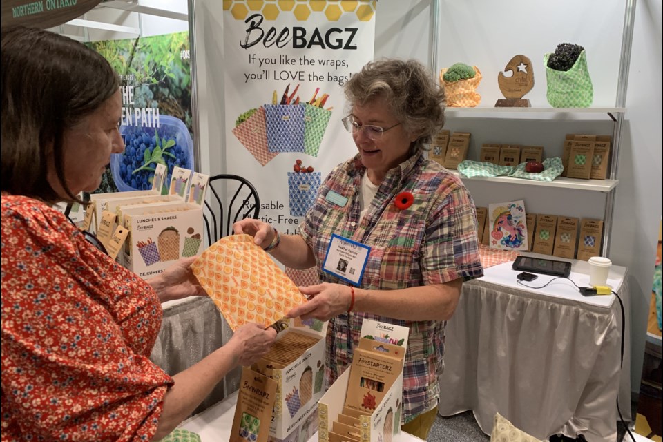 BeeBAGZ employee Heather Pascoe explains her product to a prospective customer at the Royal Agricultural Winter Fair.