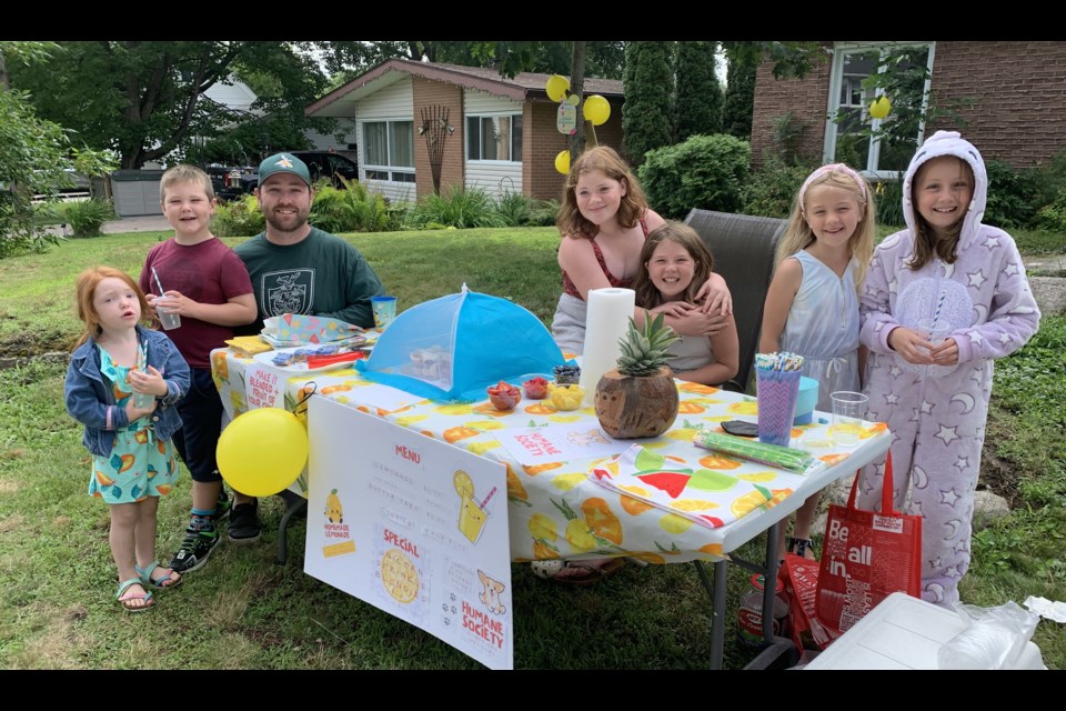 Plenty of goodies at the Bilodeau Lemonade Stand on Birch St.  Ella and Kaycee are second and third from the right.