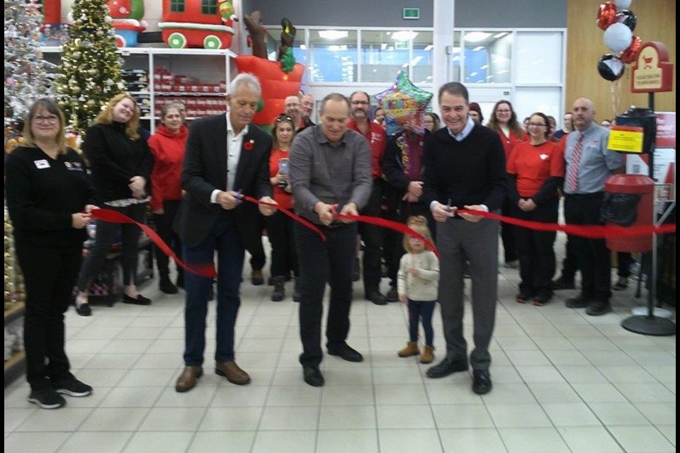 Mayor Peter Chirico, owner Dwayne Ouellet and MP Anthony Rota cut the opening ribbon.