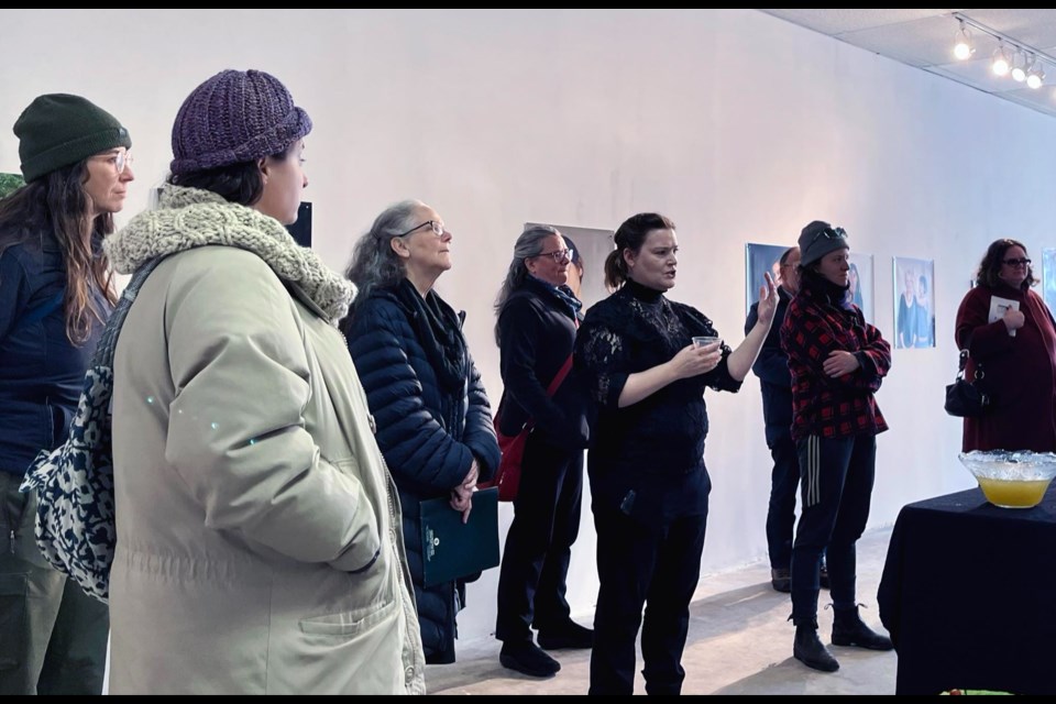 Artist Clare Samuel speaking at her exhibit opening at the White Water Gallery on March 23, 2023. 