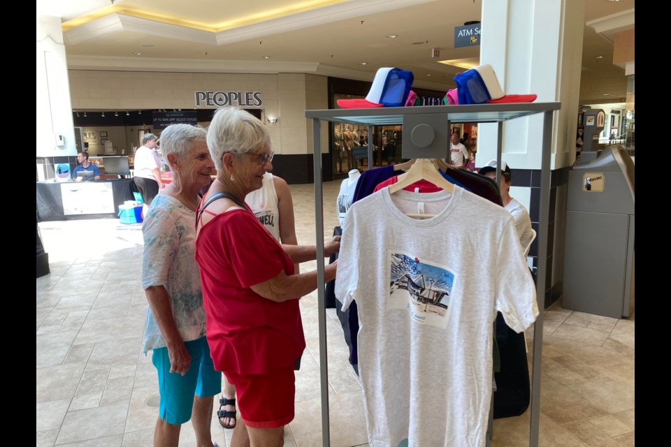 Customers check out Max Ryan's design work for his business Georgian Bay Merchandising. Photo by Matthew Sookram. 