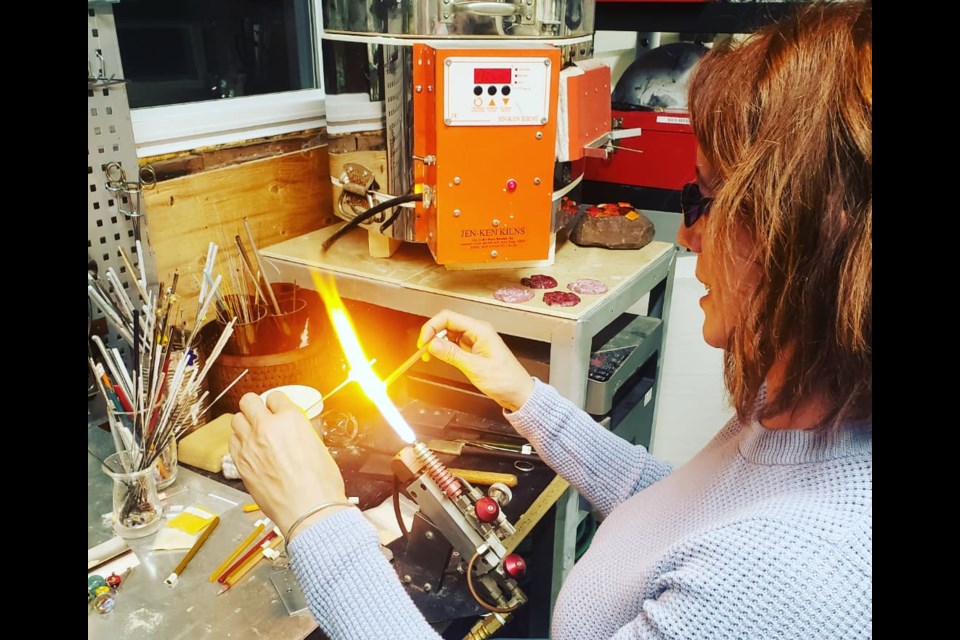 Angela Legere working on a glass fusing project. Photo provided by Angela Legere. 