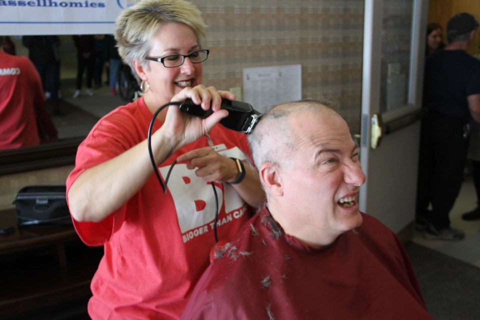 Cassellholme CEO Jamie Lowery cringes while his head is shaved as part of a Casselholme relay for life fundraiser.  Photo by Chris Dawson/BayToday.ca. 