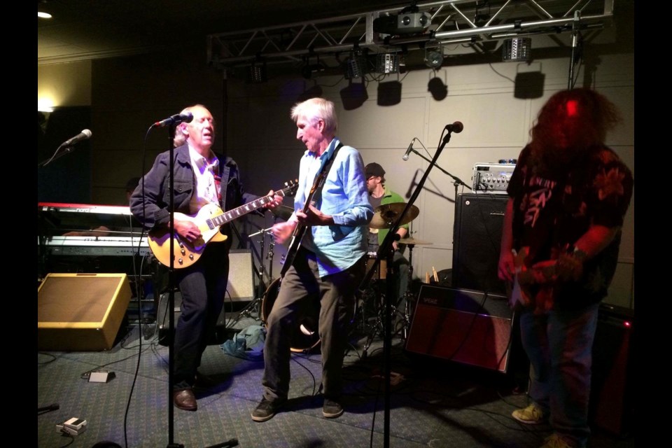 Jake Thomas (right, in blue shirt) on the guitar and members of the Fundamentals jam in honour of Jim Harney.  Photo by Arwyn Paterson.  
