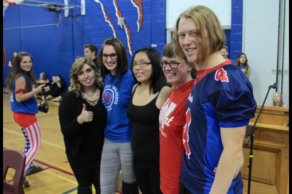 Riley Gravelle (right) with his classmates and teacher Heather Windrem after all four got their hair cut with the locks going to wigs for cancer patients.  Photo by Chris Dawson. 