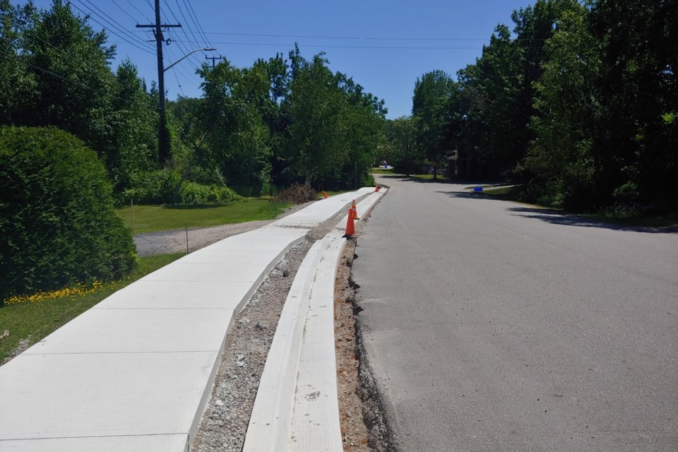 A new sidewalk along Lakeside Drive, leading toward the Birchaven Cove.