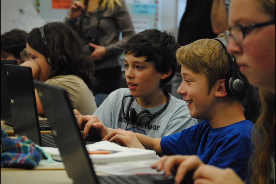 Students from St. Luke take part in the Hour of Code, Friday. Photo by Stu Campaigne.