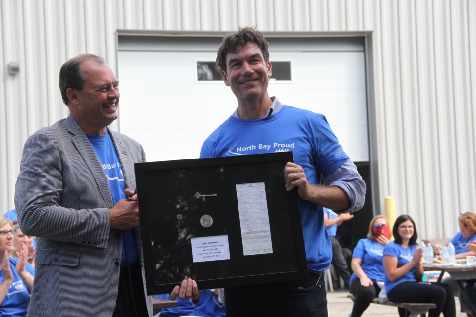 Jerry O'Connell receives his framed key to the city including his first parking ticket and some military coins.  Photo by Hannah Knight. 