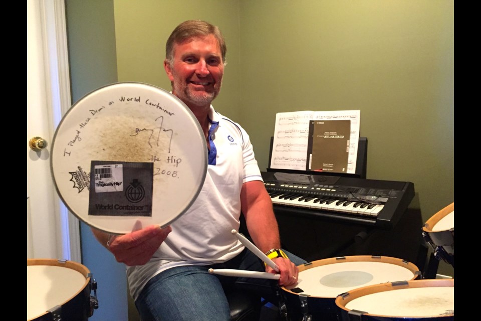 Rob Graham shows off the Drum skin signed by legendary Tragically Hip drummer Johnny Fay.  Photo by Chris Dawson.