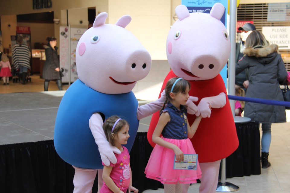 Peppa Pig and her brother George delighted children at Northgate. Here, sisters Evelyn and Hazel Craig pose with the cartoon stars. Photos by Jeff Turl.