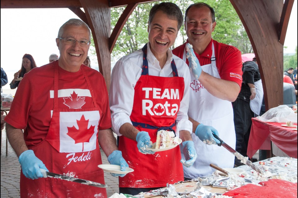 Nipissing MPP Vic Fedeli, Nipissing - Timiskaming MP Anthony Rota and North Bay Mayor Al McDonald serve a deluxe Canada Day cake at the Waterfront ACT shelter.  