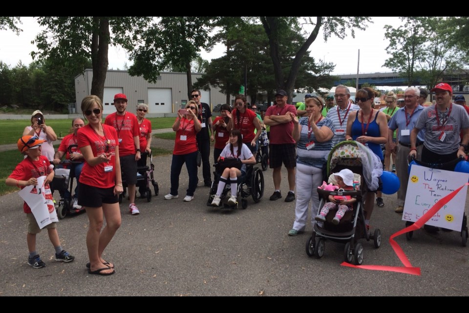 Meagan Wills cuts the ribbon to start the North Bay Walk for Muscular Dystrophy. Photo by Jeff turl. 