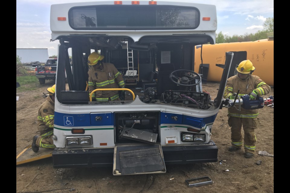 North Bay Firefighters doing bus extrication training at Fern Piche & Sons lot.  Photo by Chris Dawson/BayToday. 