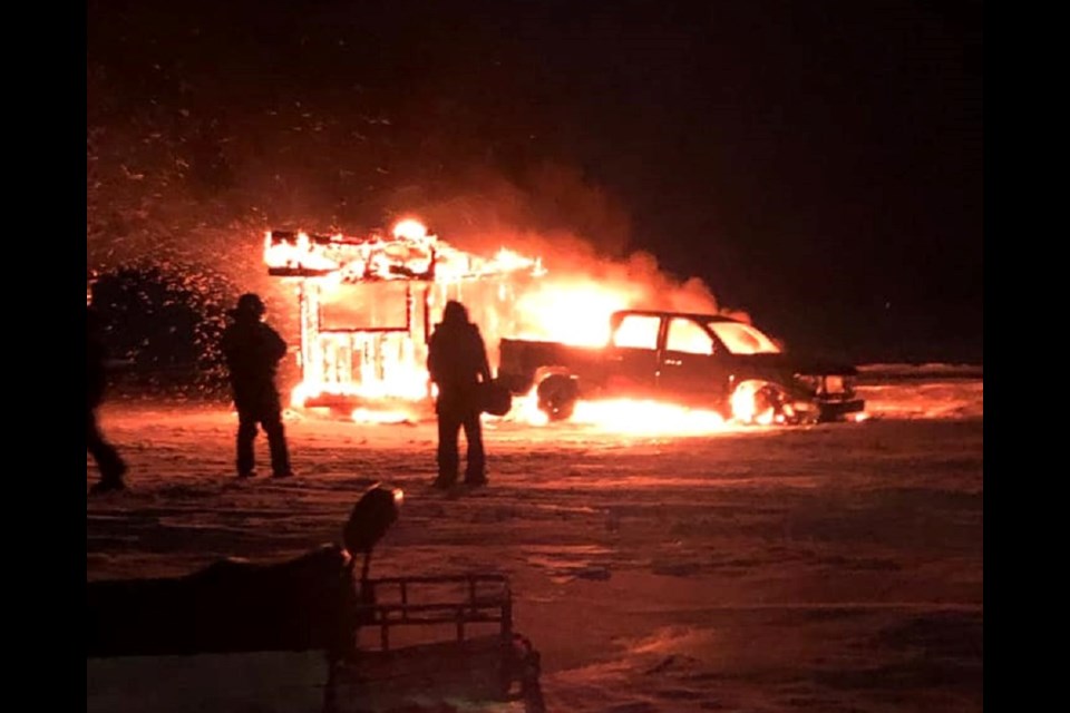 This Lake Nipissing ice hut and nearby pickup burst into flames Sunday evening. Courtesy Nikki Weckwerth.