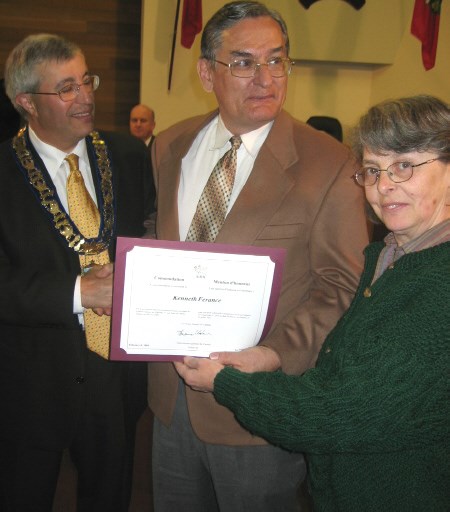 Ken Ferance and his wife Linda Hearst display the Governor-General's Commendation Mayor Vic Fedeli presented to Ferance before Monday night's meeting.