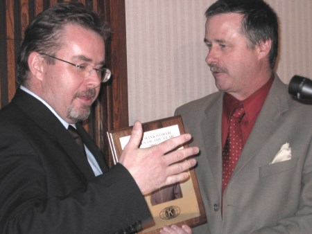 Brian Winkworth receives his citizen of the year plaque from Kiwanis Club president David Kilgour.