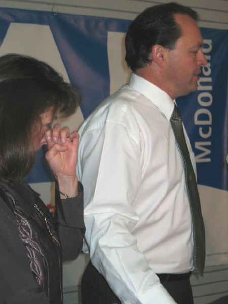 Al McDonald's partner Wendy Abdallah dabs a tear after he thanks supporters for their help.