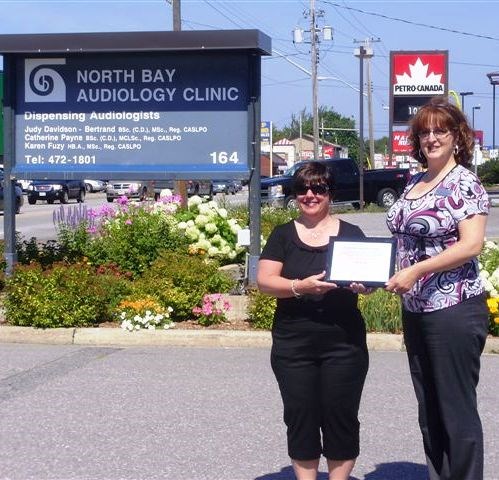 Pictured in front of the garden is Judy Davidson-Bertrand, audiologist, and Kathryn Takacs, North Bay Blooms Chair. 