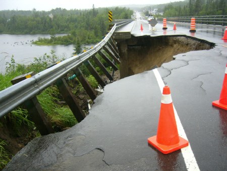 Part of a bridge was washed away during rainstorms that cause Hwy 63 to be closed for 34 hours. 