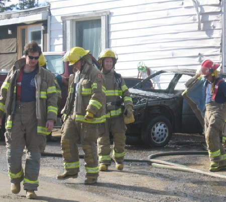 Firefighters extinguished a car fire this afternoon at a house on the North highway.