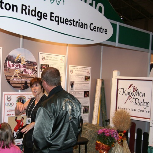 Roberte Cardwell talks to visitors at The Royal Winter Fair about Knowlton Ridge Equestrian Centre in Powassan, Ontario
