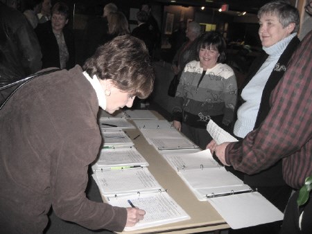 A petition presented to council Tuesday night by four former North Bay mayors is signed just outside the council chamber. Photo by Phil Novak, BayToday.ca</b>