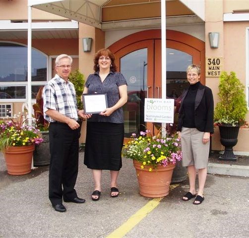 Pictured are Christian Fortin, General Manager of Inn on the Bay, Kathryn Takacs of North Bay Blooms and Patti Carr of the Chamber of Commerce.