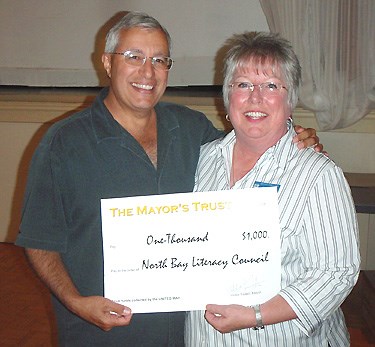 Mayor Victor Fedeli presented $1,000 to Jane Jackson at the North Bay Literacy Council