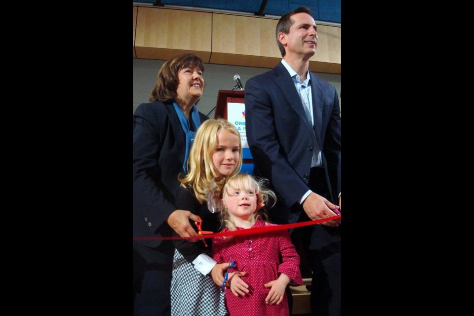 Charlotte gets some last minute advice from sister Lilly before cutting the ribbon